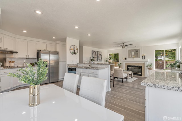 4156 N Amargosa Dr N, Antioch, CA 94531 - dining space featuring plenty of natural light, ceiling fan, a tile fireplace, light wood-style floors, and recessed lighting