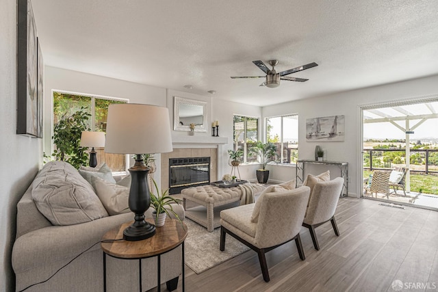 4156 N Amargosa Dr N, Antioch, CA 94531 - living area featuring ceiling fan, wood finished floors, a tile fireplace, and a textured ceiling