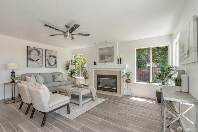 4156 N Amargosa Dr N, Antioch, CA 94531 - living room featuring a tile fireplace, light wood-type flooring, and ceiling fan