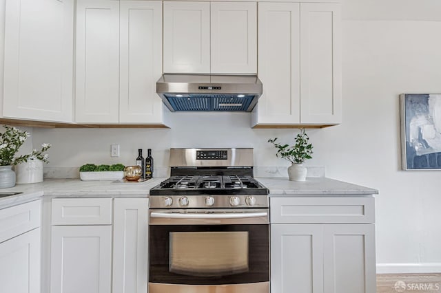 1567 44th Ave, San Francisco, CA 94122 - kitchen with stainless steel range with gas cooktop, ventilation hood, white cabinetry, and light stone countertops