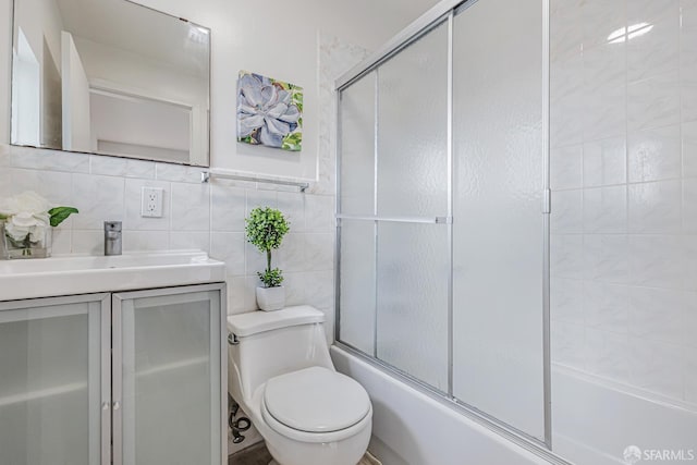 1567 44th Ave, San Francisco, CA 94122 - bathroom featuring bath / shower combo with glass door, vanity, and tile walls