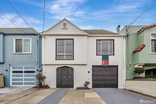1567 44th Ave, San Francisco, CA 94122 - townhome / multi-family property with driveway, a garage, stucco siding, and a shingled roof