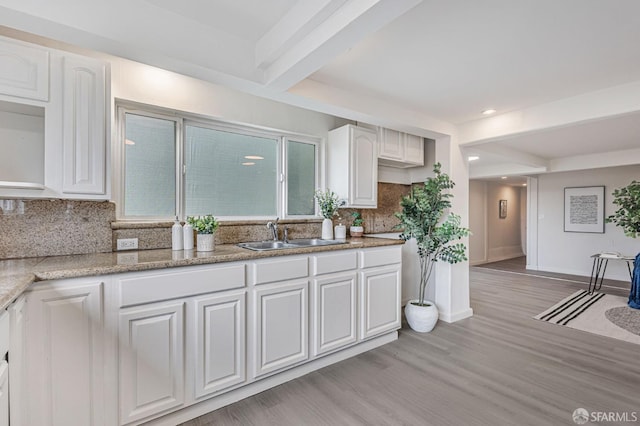 1567 44th Ave, San Francisco, CA 94122 - kitchen featuring white cabinets, light wood-style floors, backsplash, beam ceiling, and light stone countertops