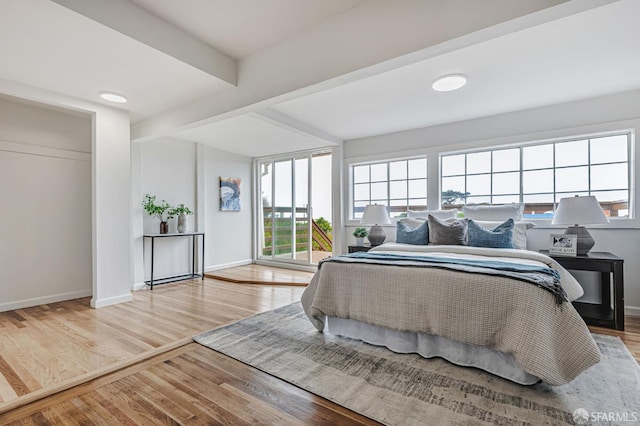 1567 44th Ave, San Francisco, CA 94122 - bedroom with wood finished floors, beamed ceiling, and access to exterior