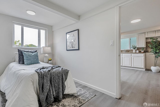 1567 44th Ave, San Francisco, CA 94122 - bedroom with multiple windows, light wood finished floors, and beam ceiling