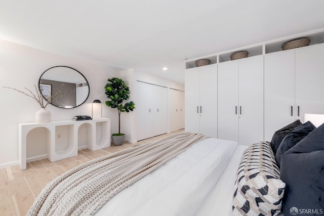 1970 Sutter St Unit 107, San Francisco, CA 94115 - bedroom with light wood-style floors, recessed lighting, and two closets