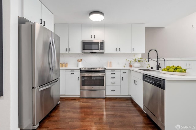 1970 Sutter St Unit 107, San Francisco, CA 94115 - kitchen with appliances with stainless steel finishes, dark wood finished floors, backsplash, and light countertops