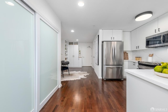 1970 Sutter St Unit 107, San Francisco, CA 94115 - kitchen featuring stainless steel appliances, dark wood-style floors, recessed lighting, light countertops, and white cabinets