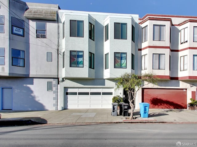 1279 41st Ave, San Francisco, CA 94122 - view of property featuring stucco siding, an attached garage, and concrete driveway
