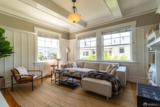 living room with wood-type flooring, beam ceiling, and ornamental molding