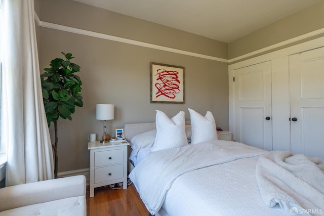 bedroom with a closet and hardwood / wood-style flooring