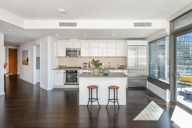 1 Hawthorne St Unit 12F, San Francisco, CA 94105 - kitchen with dark wood finished floors, stainless steel appliances, white cabinets, and recessed lighting