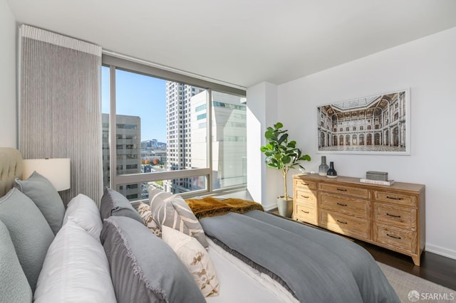 1 Hawthorne St Unit 12F, San Francisco, CA 94105 - bedroom with dark wood-style flooring, a city view, and expansive windows