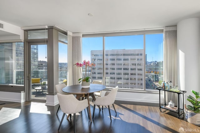 1 Hawthorne St Unit 12F, San Francisco, CA 94105 - dining area featuring a view of city, wood-type flooring, healthy amount of natural light, and expansive windows
