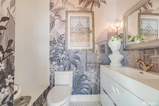 bathroom with tile patterned flooring, vanity, and toilet