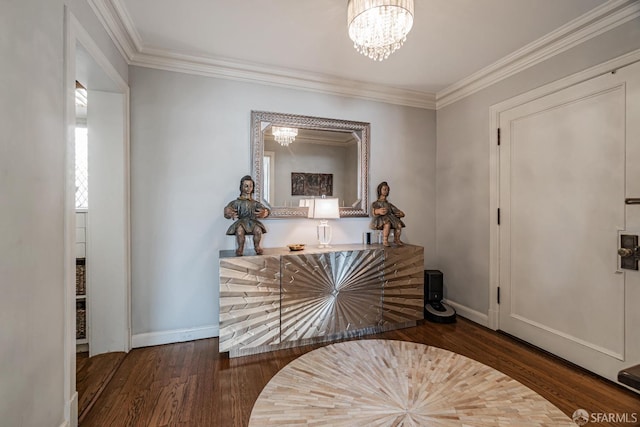 entrance foyer with an inviting chandelier, crown molding, and dark wood-type flooring