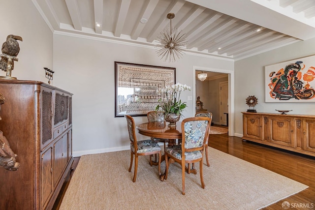 dining area featuring wood-type flooring, an inviting chandelier, crown molding, and beam ceiling