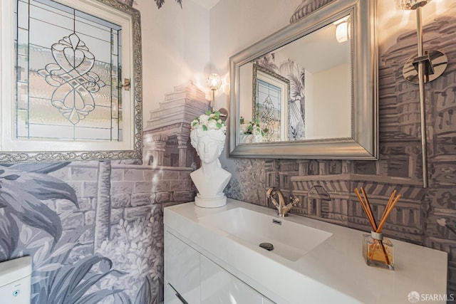 bathroom with backsplash, vanity, and toilet