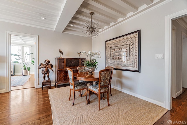 dining room with an inviting chandelier, beam ceiling, dark wood-type flooring, and crown molding