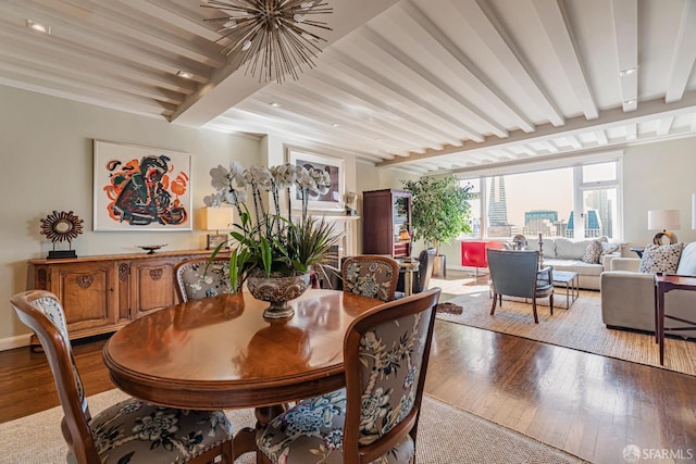 dining space with beamed ceiling and light hardwood / wood-style flooring