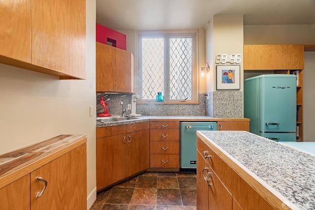 kitchen featuring white refrigerator, sink, tasteful backsplash, and dishwasher