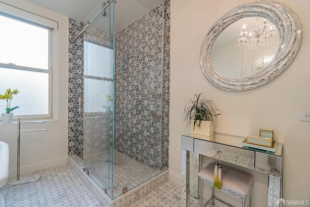 bathroom featuring tile patterned flooring, a shower with door, and a healthy amount of sunlight