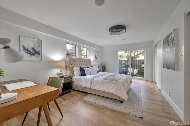 bedroom with access to outside and light hardwood / wood-style floors