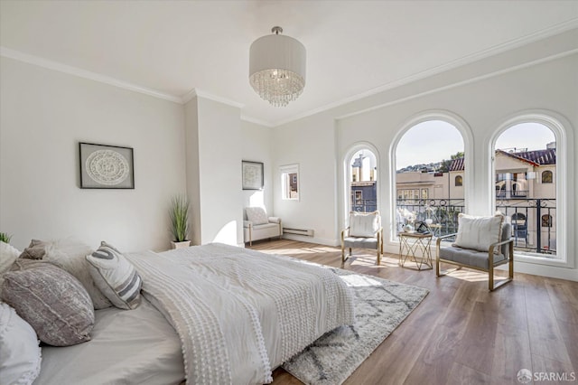 bedroom featuring an inviting chandelier, access to exterior, a baseboard heating unit, wood-type flooring, and ornamental molding