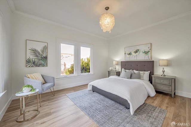 bedroom featuring ornamental molding, a chandelier, and light hardwood / wood-style floors