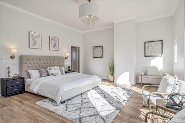 bedroom with an inviting chandelier, hardwood / wood-style flooring, and ornamental molding