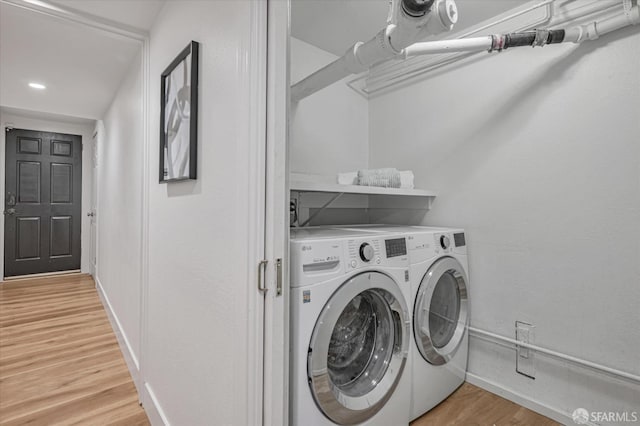 washroom with hardwood / wood-style floors and independent washer and dryer