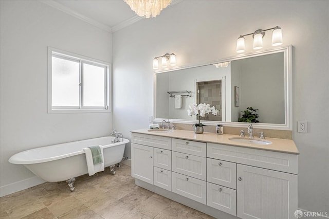 bathroom with ornamental molding, an inviting chandelier, vanity, and a bathtub