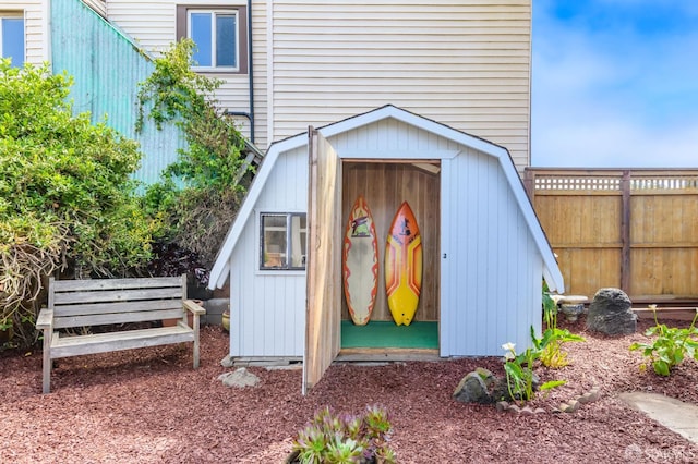 view of shed featuring fence