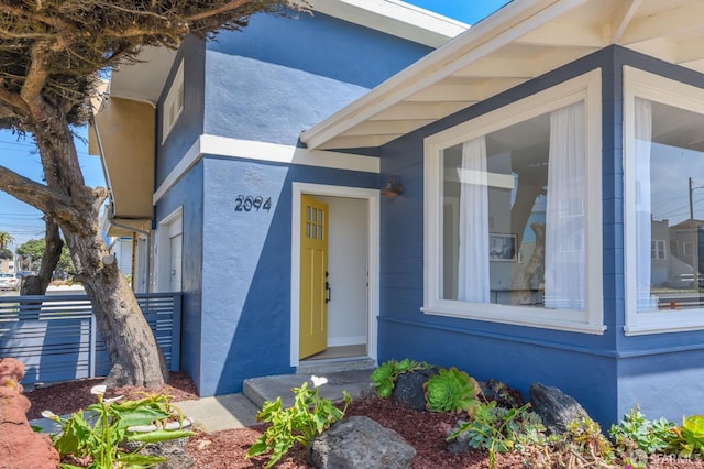 doorway to property with stucco siding