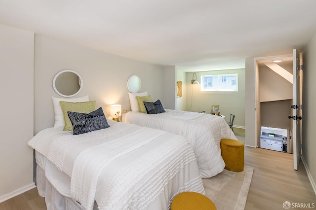 bedroom with light wood-style floors and baseboards