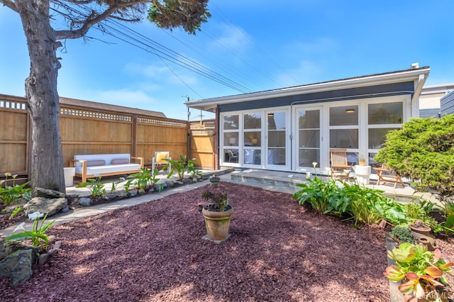 view of yard featuring a sunroom, a patio area, and fence
