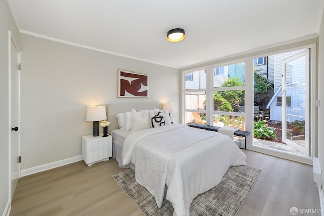 bedroom with baseboards and light wood-type flooring