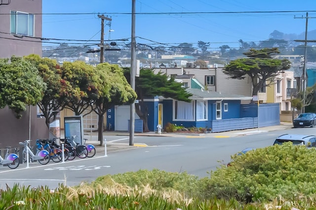view of street with curbs, street lights, and sidewalks