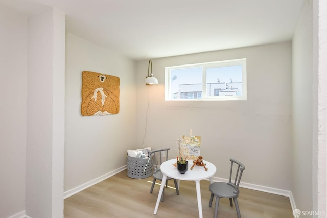 dining area featuring baseboards and wood finished floors