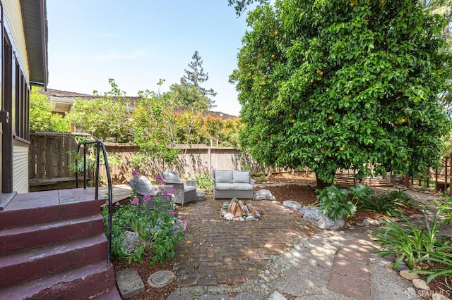 view of yard featuring a patio, outdoor lounge area, and fence