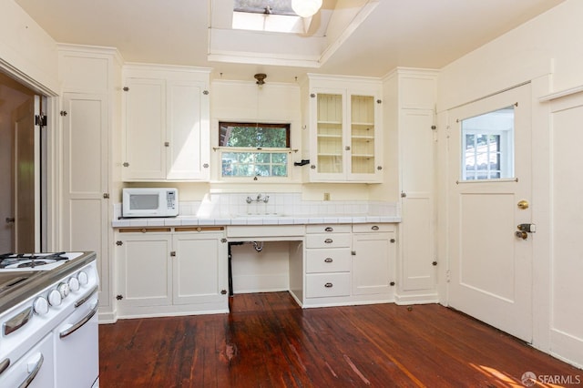 kitchen with white appliances, tile counters, white cabinetry, and dark wood-type flooring