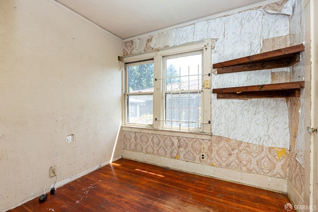 empty room featuring baseboards and hardwood / wood-style floors
