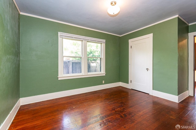 unfurnished bedroom featuring baseboards, ornamental molding, and hardwood / wood-style flooring