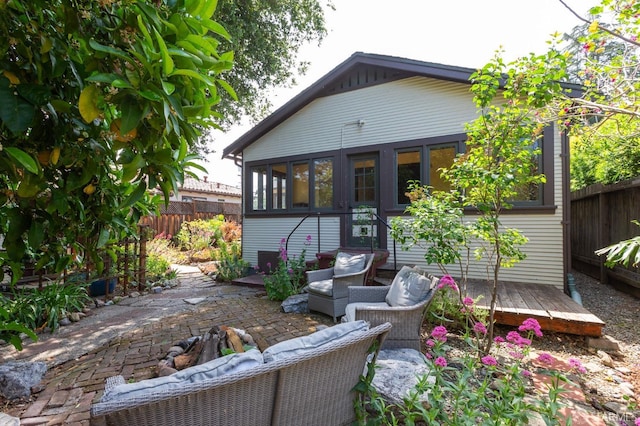 back of property with a patio, fence, and an outdoor living space