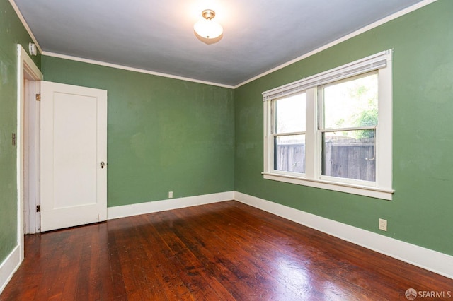 unfurnished room with crown molding, baseboards, and hardwood / wood-style floors