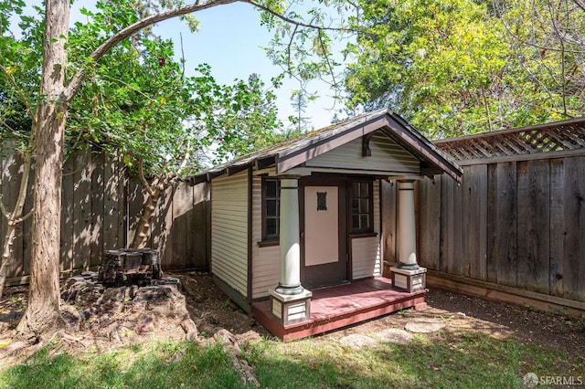 view of outbuilding featuring a fenced backyard and an outbuilding