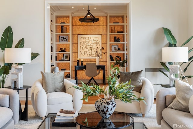 living room with built in features and crown molding
