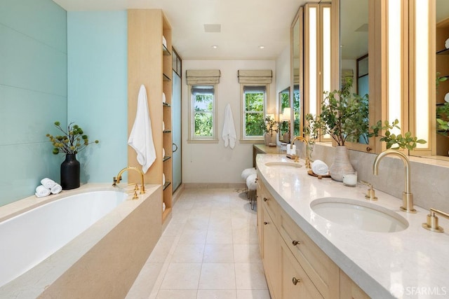 full bathroom with a sink, double vanity, a bath, and tile patterned floors