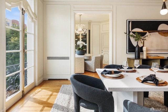 dining room featuring a chandelier and light wood-style flooring