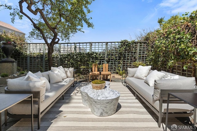 wooden deck with fence and an outdoor hangout area